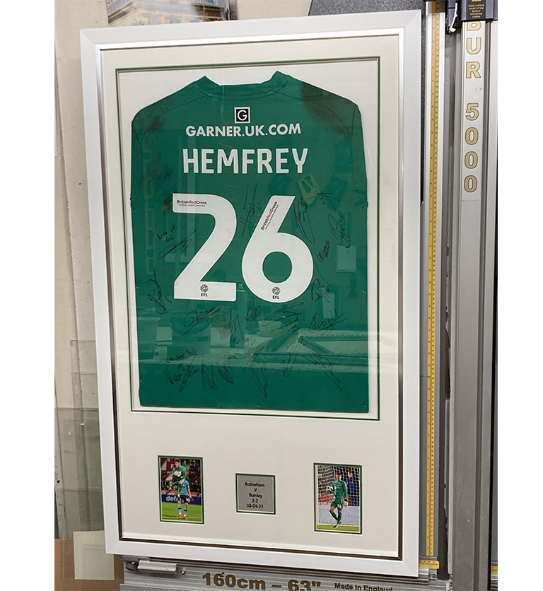 Framed football top with printed plaque